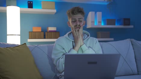 Worried-and-insecure-discouraged-young-man-using-laptop-at-home